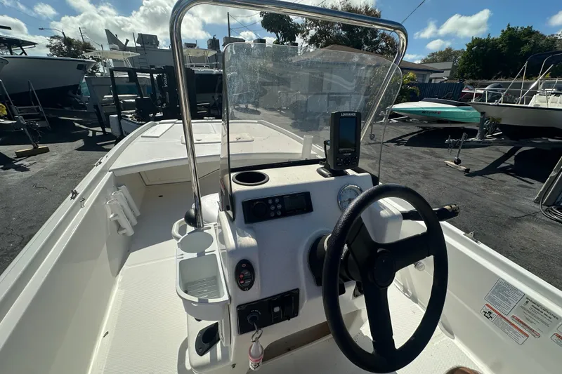 Slide: The Image of 2015 Mako Pro Skiff 17 CC boat console with steering wheel and navigation equipment. - 10