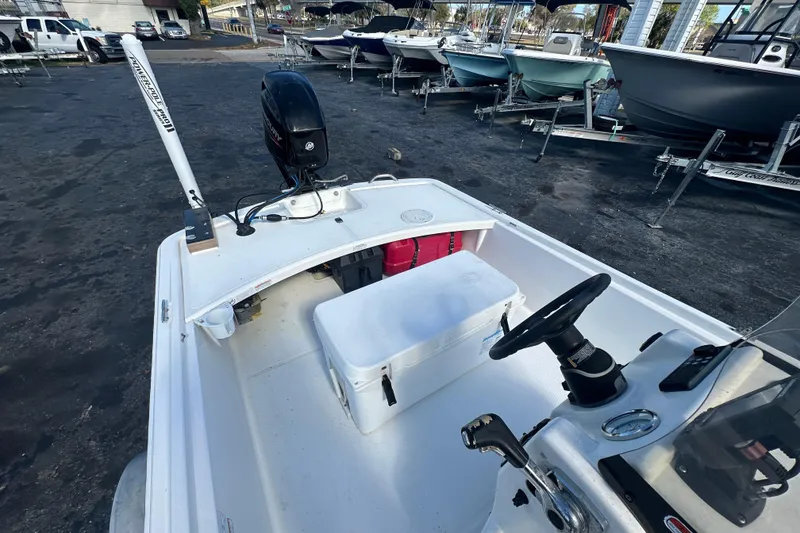 Slide: The Image of 2015 Mako Pro Skiff 17 CC boat with outboard motor, parked on a trailer. - 12