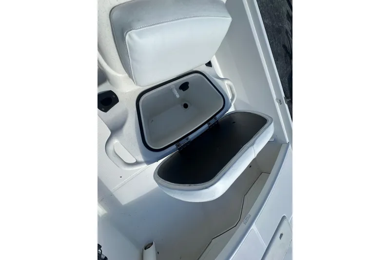 Slide: The Image of 2015 Mako Pro Skiff 17 CC boat seat with open storage compartment. - 14