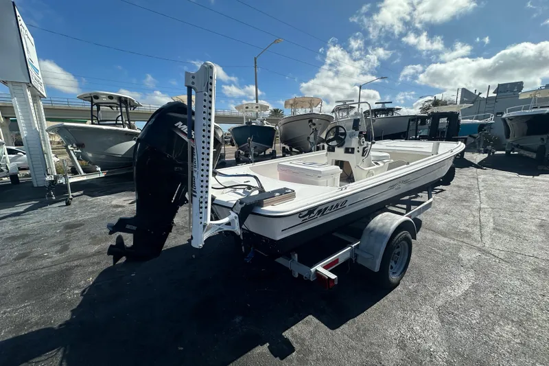 Slide: The Image of 2015 Mako Pro Skiff 17 CC boat on trailer under clear sky. - 2