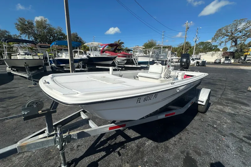 Slide: The Image of 2015 Mako Pro Skiff 17 CC boat on trailer under clear blue sky. - 7