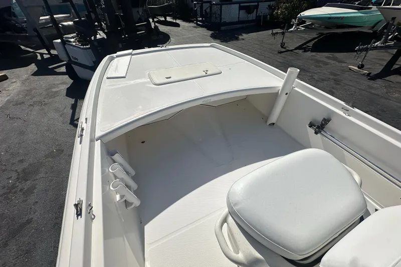 Slide: The Image of 2015 Mako Pro Skiff 17 CC boat interior with seating and storage compartments. - 8