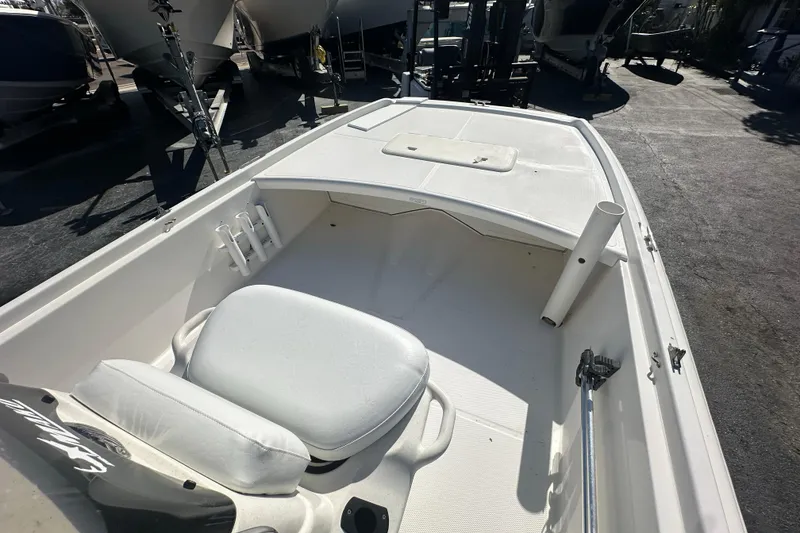 Slide: The Image of 2015 Mako Pro Skiff 17 CC boat interior with seating and storage compartments. - 9