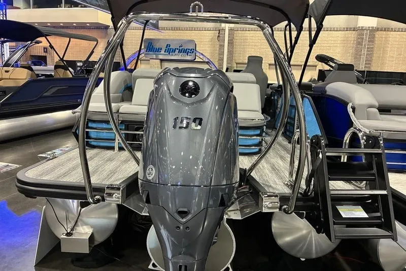 Slide: The Image of 2026 Bennington 22 MSB pontoon boat with powerful 150 HP engine at a boat show. - 4