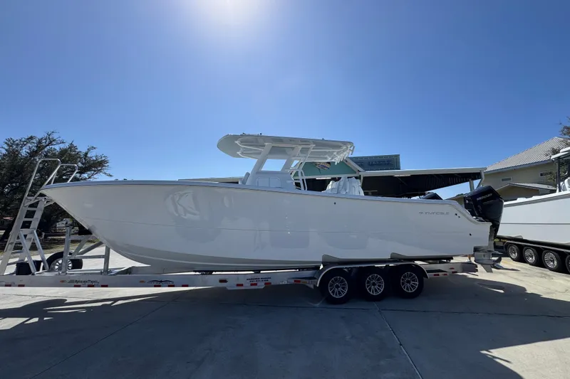 The Image of 2026 Invincible 33 Catamaran on trailer under clear blue sky. - 1