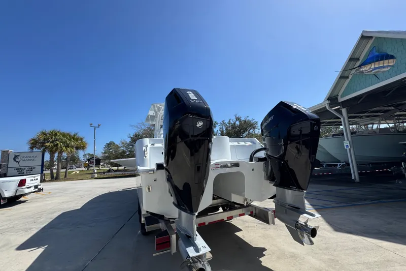 Slide: The Image of 2026 Invincible 33 Catamaran with dual Mercury outboard engines in a marina setting. - 16