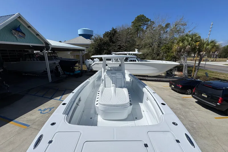 Slide: The Image of 2026 Invincible 33 Catamaran in marina, showcasing sleek design and spacious deck. - 20