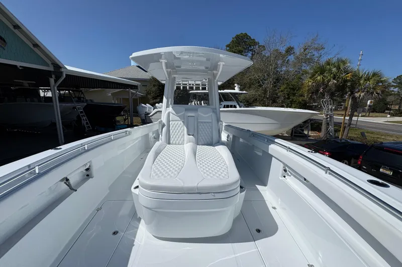 Slide: The Image of 2026 Invincible 33 Catamaran with sleek white interior and modern seating design. - 21