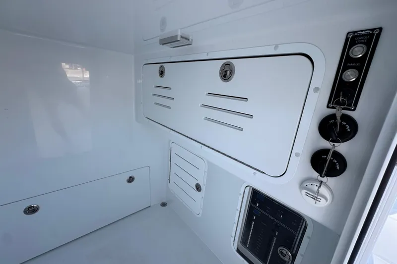 Slide: The Image of Interior view of 2026 Invincible 33 Catamaran with control panel and storage compartments. - 28