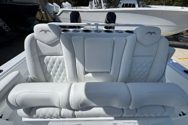 Slide: The Image of 2026 Invincible 33 Catamaran with luxurious white seating and diamond stitching. - 30