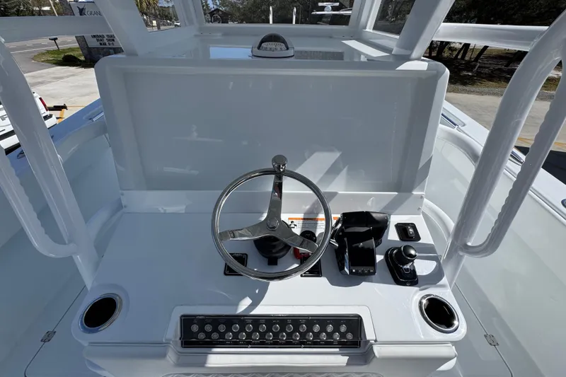 Slide: The Image of Helm of 2026 Invincible 33 Catamaran featuring steering wheel and control panel. - 33