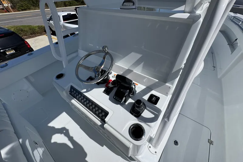 Slide: The Image of Helm of 2026 Invincible 33 Catamaran with steering wheel and controls. - 34