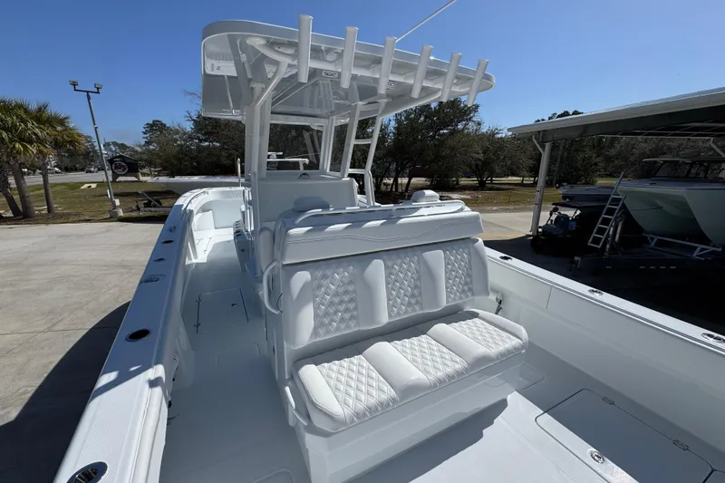 Slide: The Image of 2026 Invincible 33 Catamaran with sleek white seating and modern design. - 36