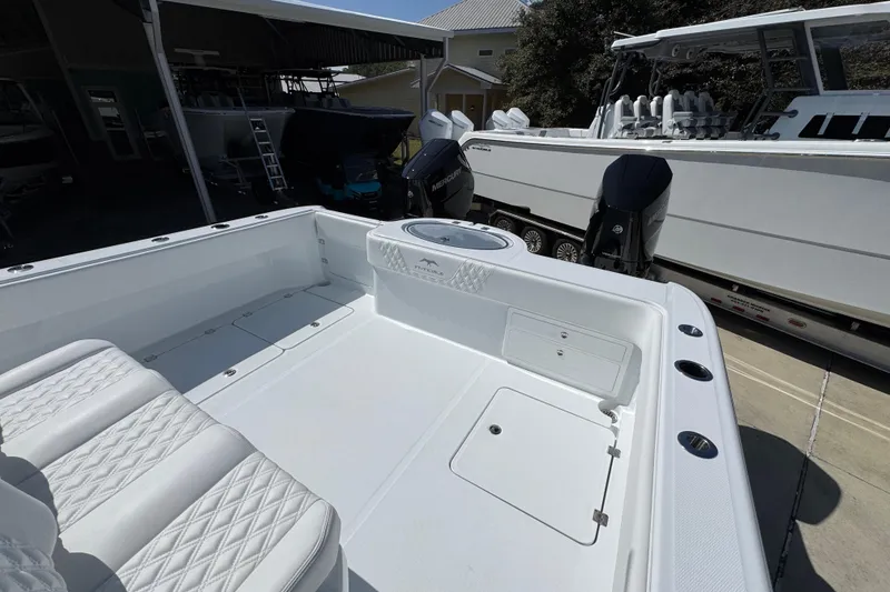 Slide: The Image of 2026 Invincible 33 Catamaran with spacious deck and modern seating in a marina setting. - 39