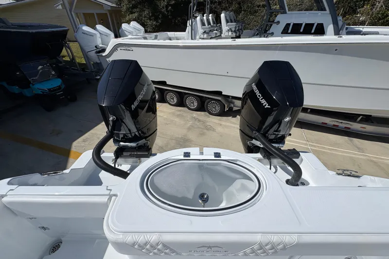 Slide: The Image of 2026 Invincible 33 Catamaran with dual Mercury outboard engines, docked on a trailer. - 41