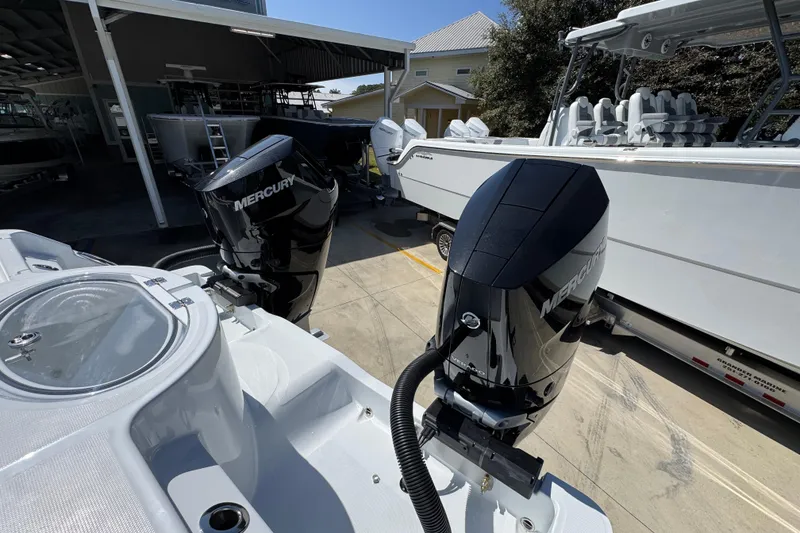 Slide: The Image of 2026 Invincible 33 Catamaran with dual Mercury outboard engines in a marina setting. - 42