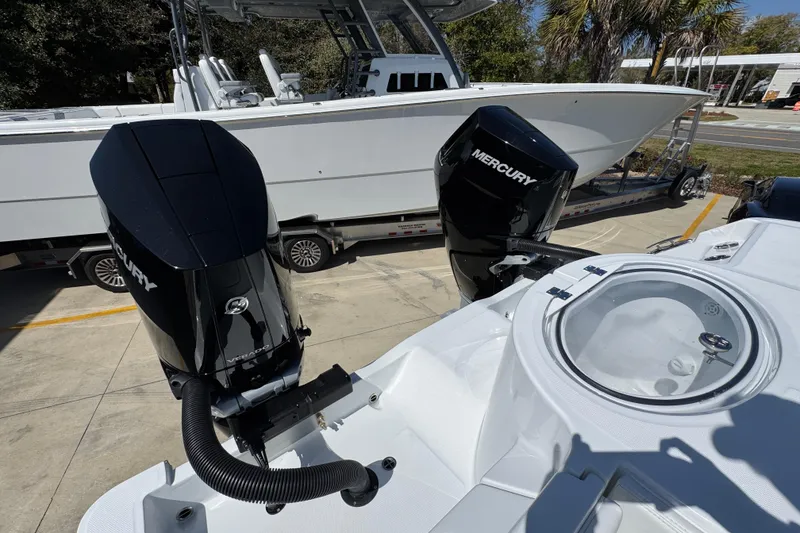 Slide: The Image of 2026 Invincible 33 Catamaran with dual Mercury outboard engines, parked on a trailer. - 43