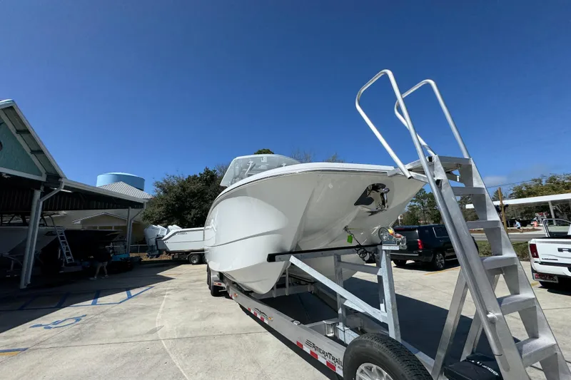 Slide: The Image of 2026 Invincible 33 Catamaran on trailer under clear blue sky. - 7