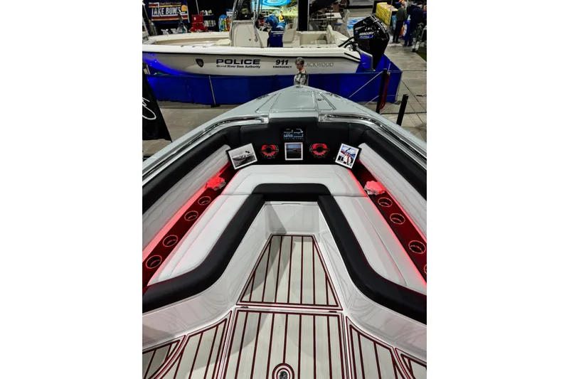 Slide: The Image of 2024 Cigarette 41' Nighthawk SD Edition boat interior with red accent lighting and seating. - 10
