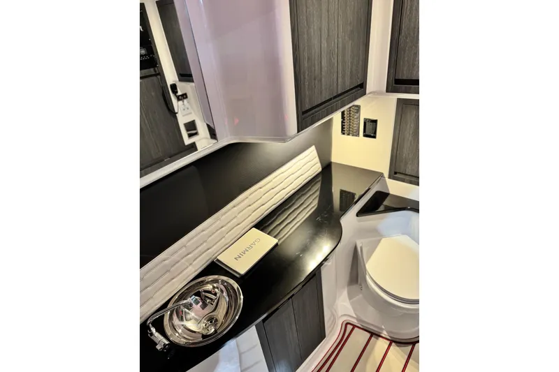 Slide: The Image of Luxurious interior of 2024 Cigarette 41' Nighthawk SD Edition boat, featuring sleek cabinetry. - 15