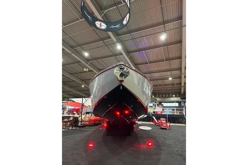 Slide: The Image of 2024 Cigarette 41' Nighthawk SD Edition boat displayed indoors with red lighting. - 18