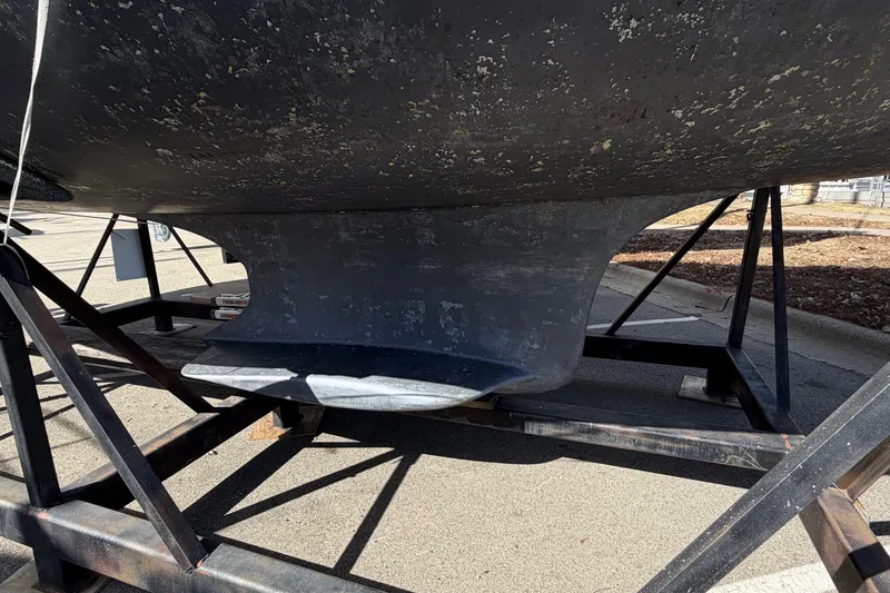 Slide: The Image of 2005 Hunter 38 sailboat keel on a metal stand, showing weathered surface. - 12