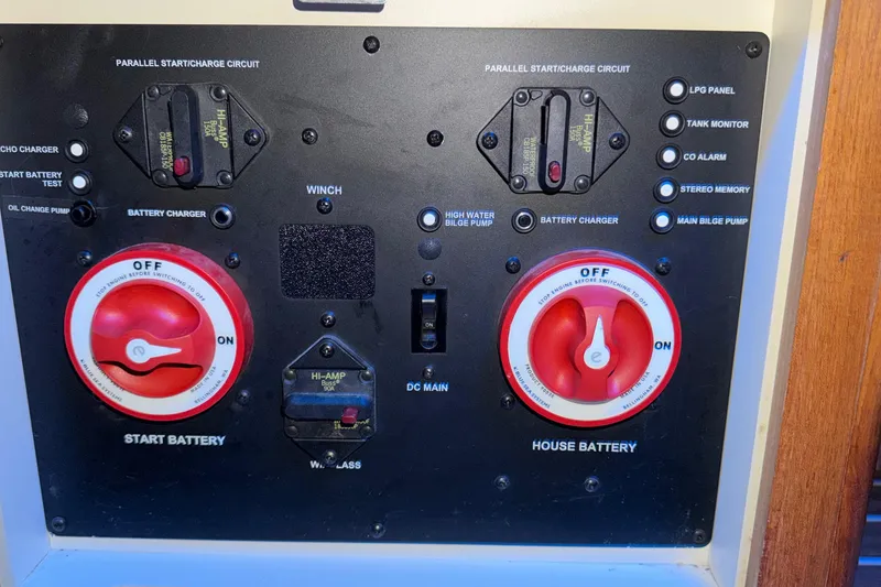 Slide: The Image of Control panel of a 2005 Hunter 38 boat with battery switches and indicators. - 13