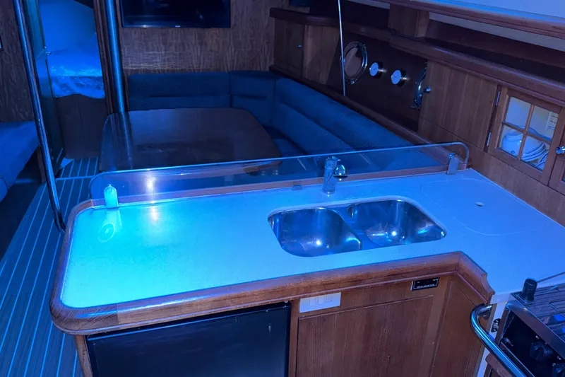 Slide: The Image of Interior of 2005 Hunter 38 yacht with kitchen sink and seating area. - 14