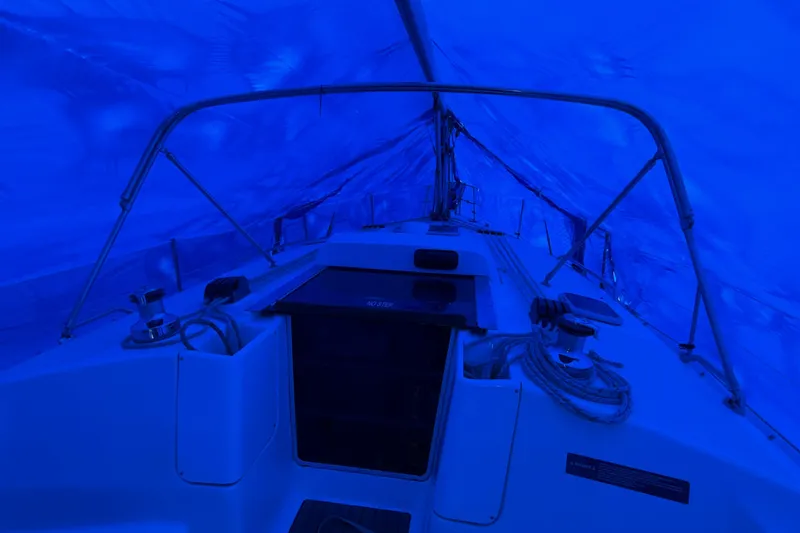 Slide: The Image of Interior view of a 2005 Hunter 38 sailboat under blue tarp cover. - 30