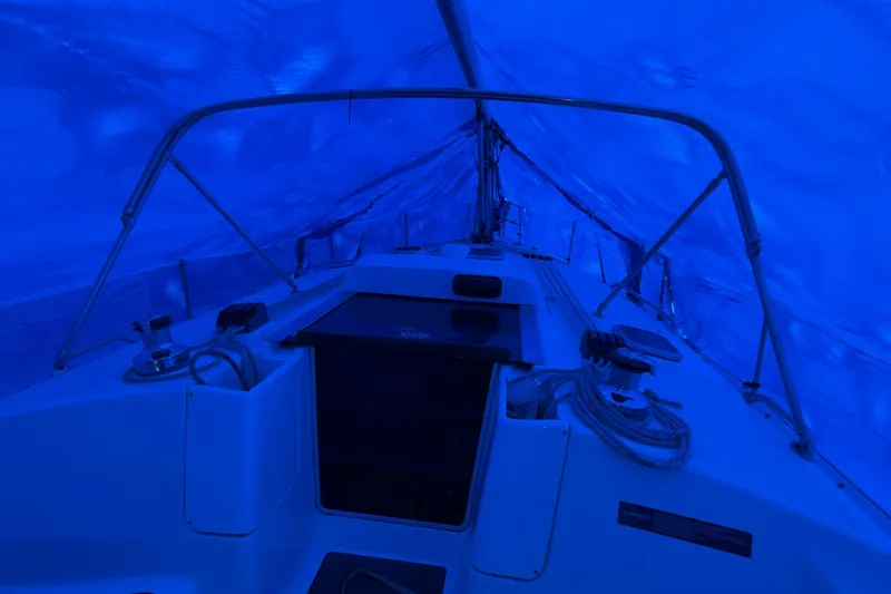 Slide: The Image of Interior view of a 2005 Hunter 38 sailboat under blue tarp cover. - 31