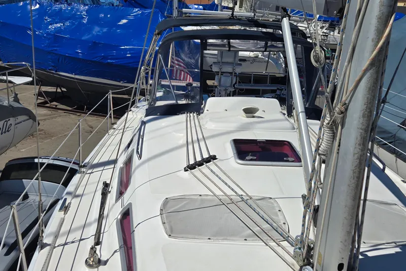 Slide: The Image of Sailboat deck view of a 2005 Hunter 38, docked with other boats. - 32