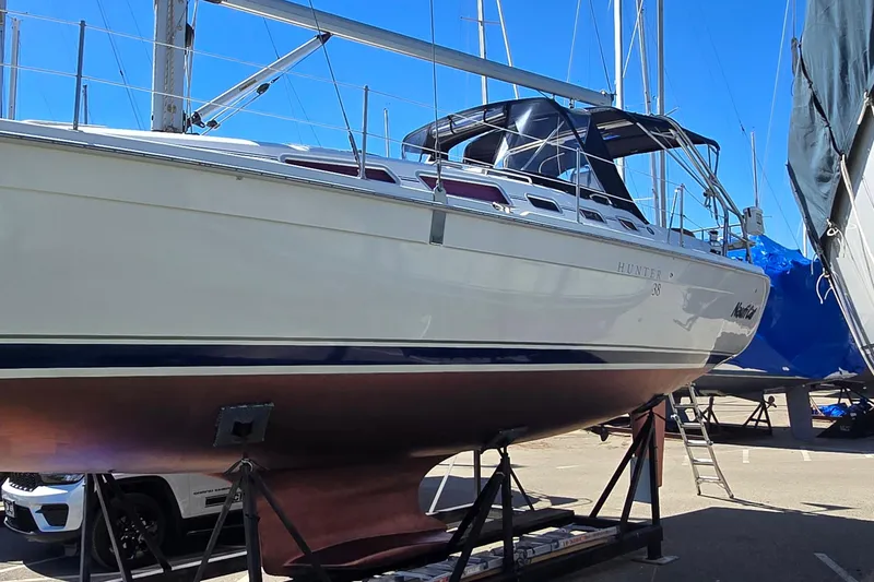 Slide: The Image of Sailboat Hunter 38, 2005 model, on dry dock with clear blue sky background. - 34