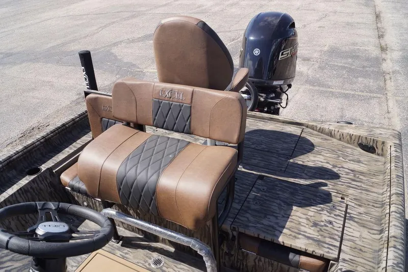 Slide: The Image of 2026 Excel 203 Bay Pro Elite boat interior with brown leather seats and steering wheel. - 11