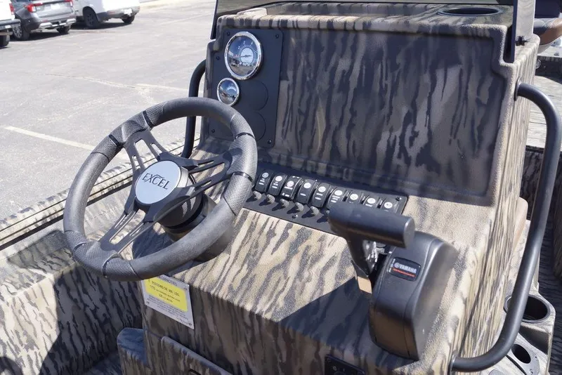 Slide: The Image of 2026 Excel 203 Bay Pro Elite boat dashboard with camo design and steering wheel. - 12