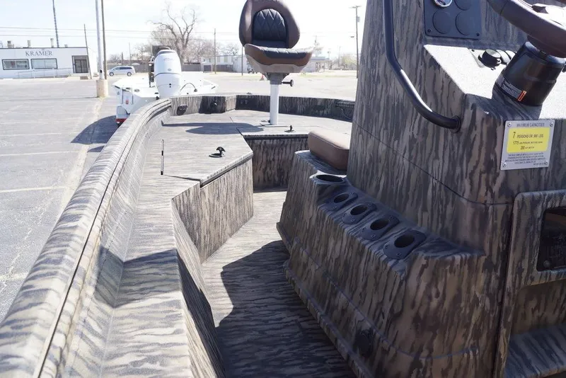 Slide: The Image of 2026 Excel 203 Bay Pro Elite boat interior with camo design and seating. - 15