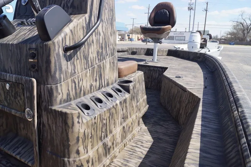 Slide: The Image of 2026 Excel 203 Bay Pro Elite boat with camouflage design and seating. - 17
