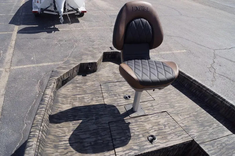 Slide: The Image of 2026 Excel 203 Bay Pro Elite boat seat with camo pattern and trailer in background. - 21