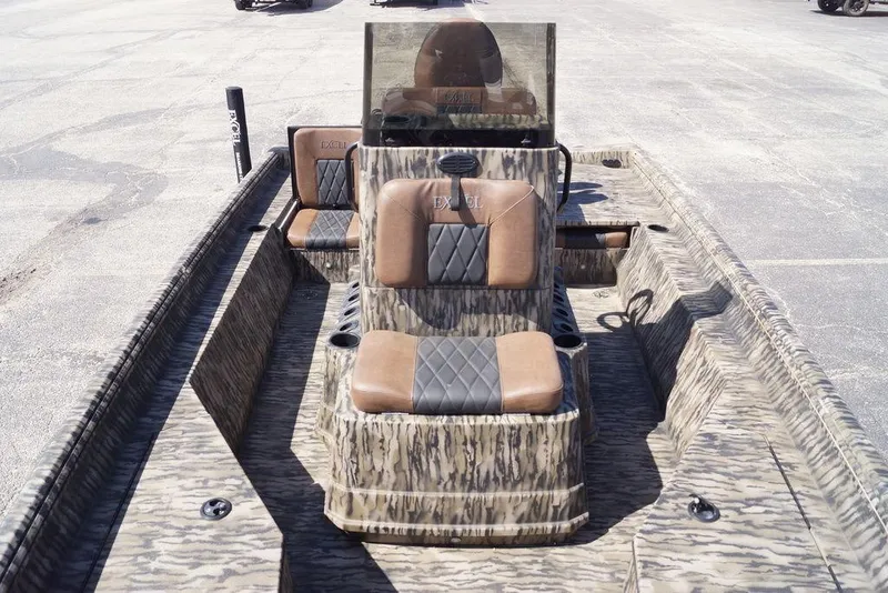 Slide: The Image of 2026 Excel 203 Bay Pro Elite boat with camouflage design and cushioned seating. - 22