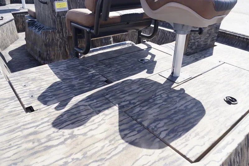 Slide: The Image of 2026 Excel 203 Bay Pro Elite boat interior with camo pattern and seating. - 9