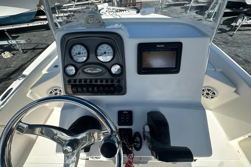 Slide: The Image of 2015 Tidewater 2000 Carolina Bay boat dashboard with steering wheel and navigation instruments. - 17