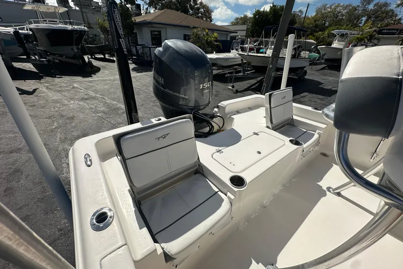 Slide: The Image of 2015 Tidewater 2000 Carolina Bay boat with Yamaha 150 engine, docked outdoors. - 18