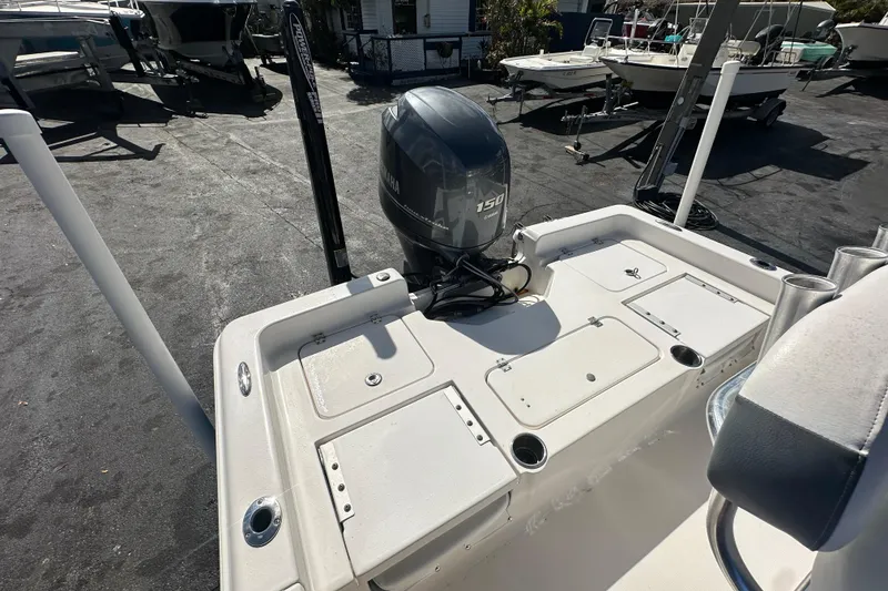 Slide: The Image of 2015 Tidewater 2000 Carolina Bay boat with Yamaha 150 engine, docked outdoors. - 19