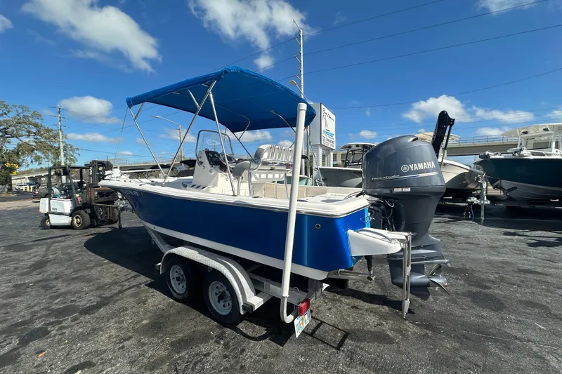 Slide: The Image of 2015 Tidewater 2000 Carolina Bay boat with Yamaha engine on trailer, blue hull, sunny day. - 2
