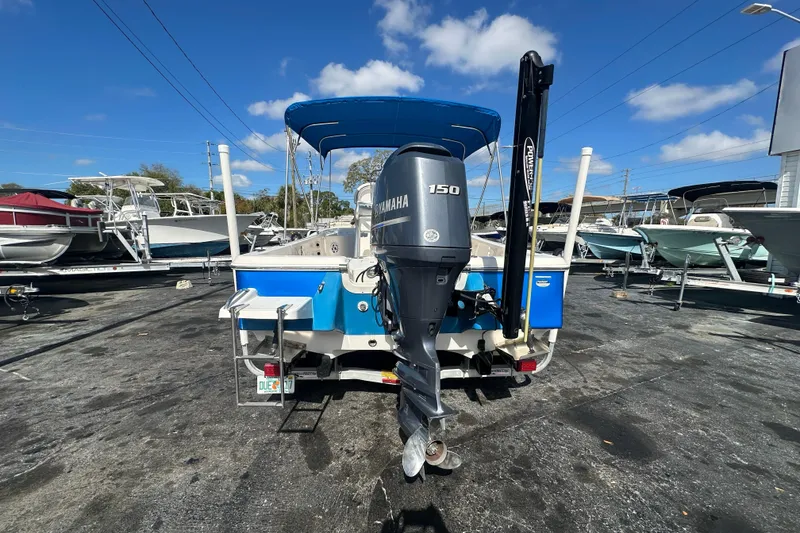 Slide: The Image of 2015 Tidewater 2000 Carolina Bay boat with Yamaha 150 engine, parked outdoors. - 3