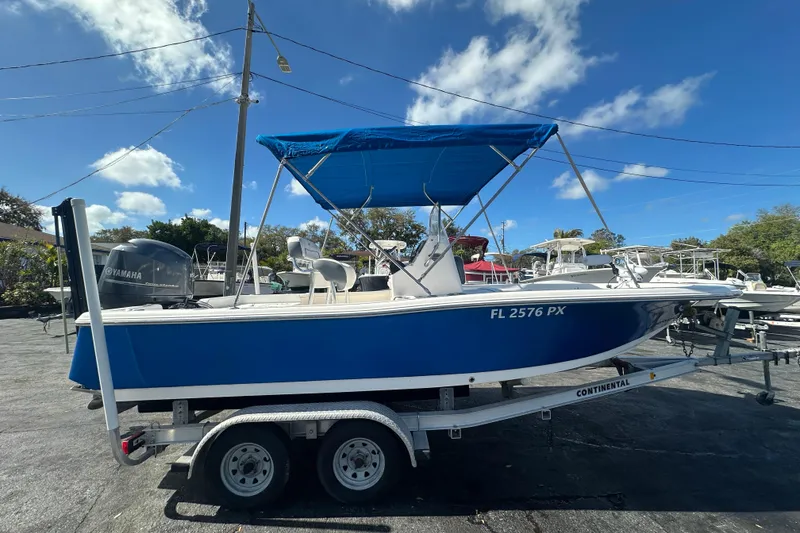Slide: The Image of 2015 Tidewater 2000 Carolina Bay boat with blue hull and Yamaha engine on trailer. - 6