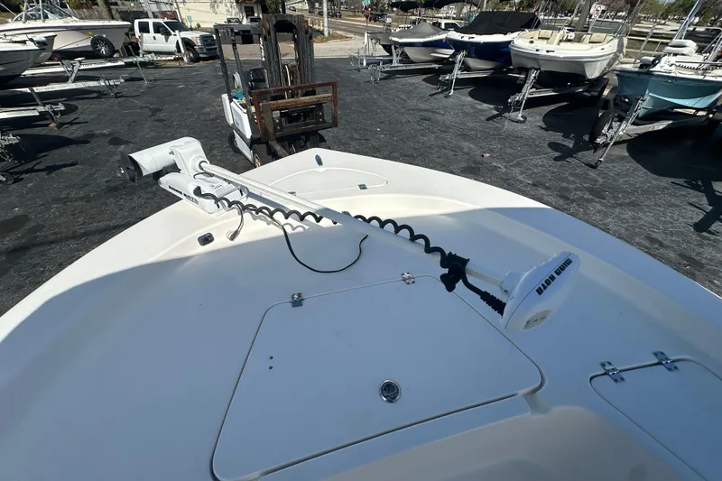 Slide: The Image of 2015 Tidewater 2000 Carolina Bay boat with trolling motor, parked in a marina. - 8