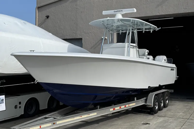 The Image of 2025 Contender 32 ST boat on trailer, featuring sleek design and Garmin equipment. - 0