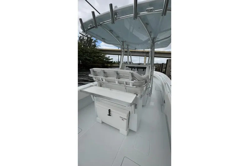 Slide: The Image of 2025 Contender 32 ST boat interior with seating and storage, under a sleek canopy. - 13