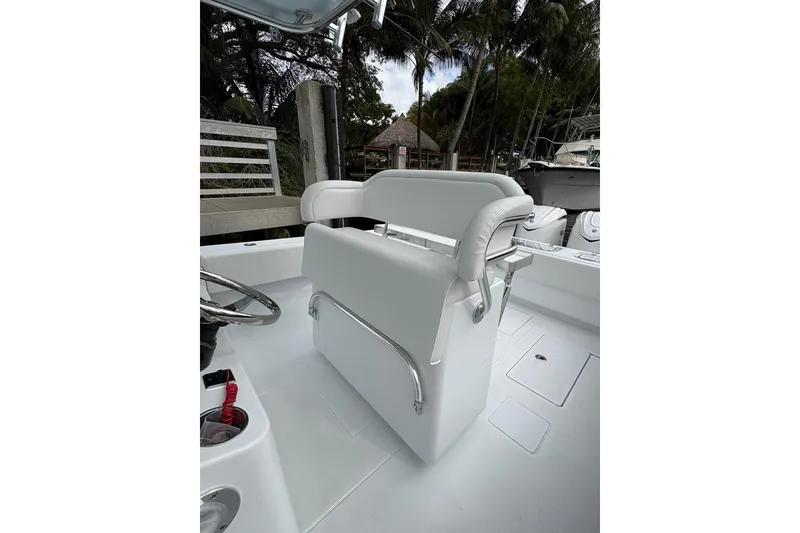 Slide: The Image of 2025 Contender 32 ST boat interior with white seating and steering wheel. - 17