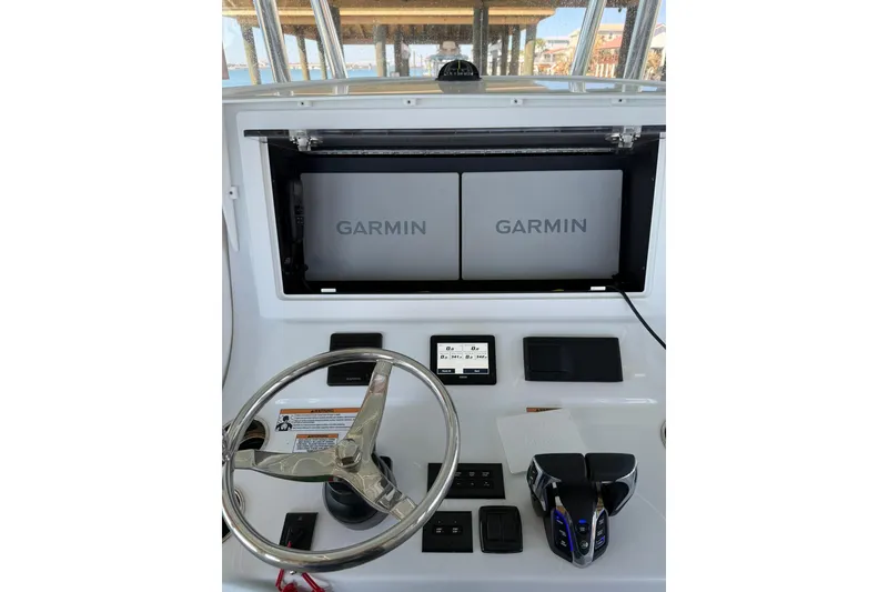 Slide: The Image of Dashboard of 2025 Contender 32 ST boat with Garmin navigation displays. - 20
